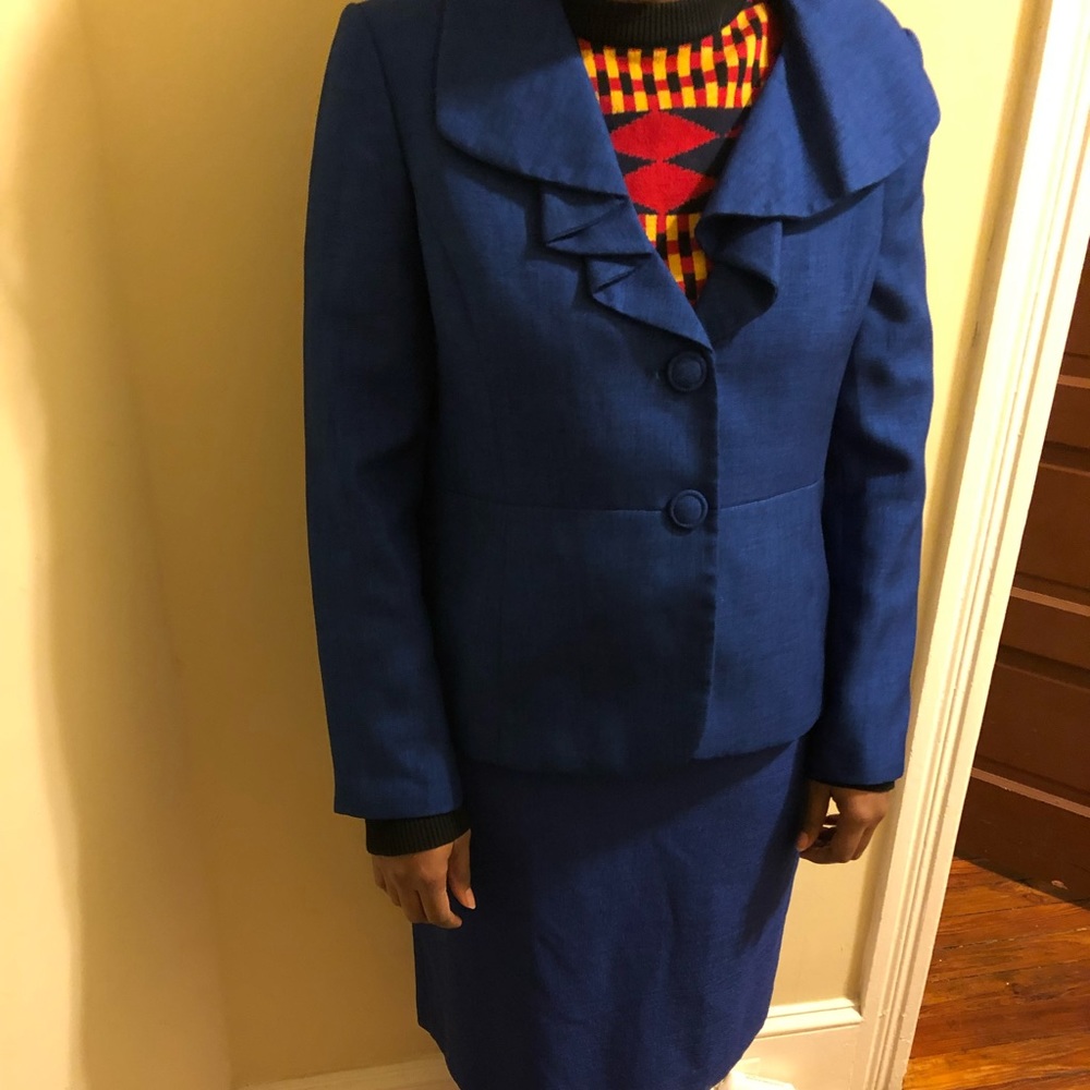 Lightly worn, Le Suit dress suit. The suit is blue and size 14